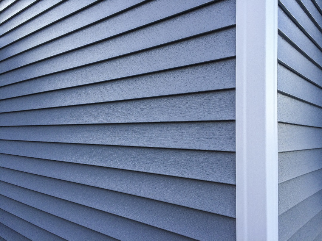Blue Vinyl Siding With White Trim On The Outside